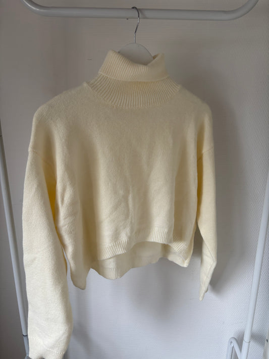 Crèmekleurige coltrui